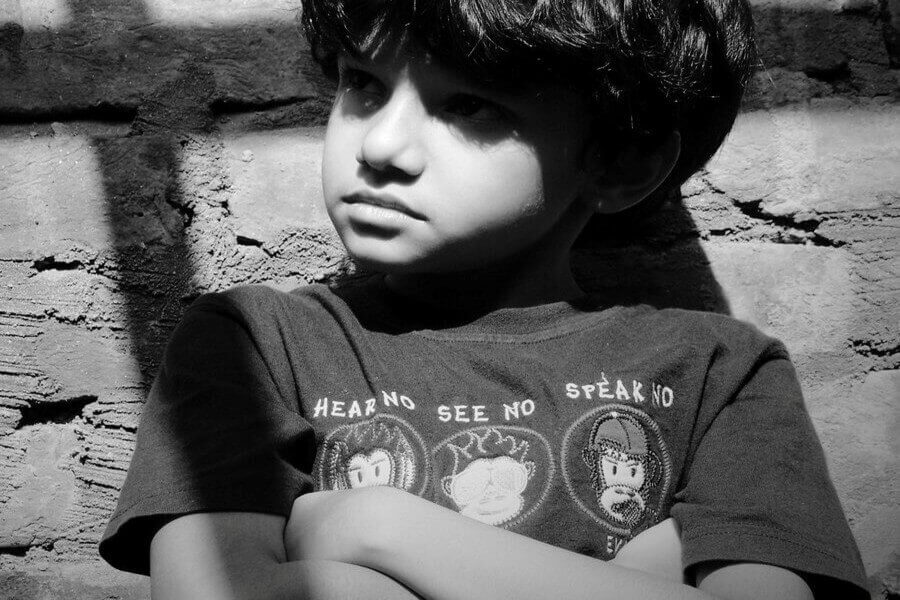 A sad young boy representing victims of abuse at Kurn Hattin