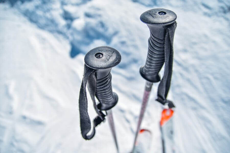 Ski poles standing in snow.